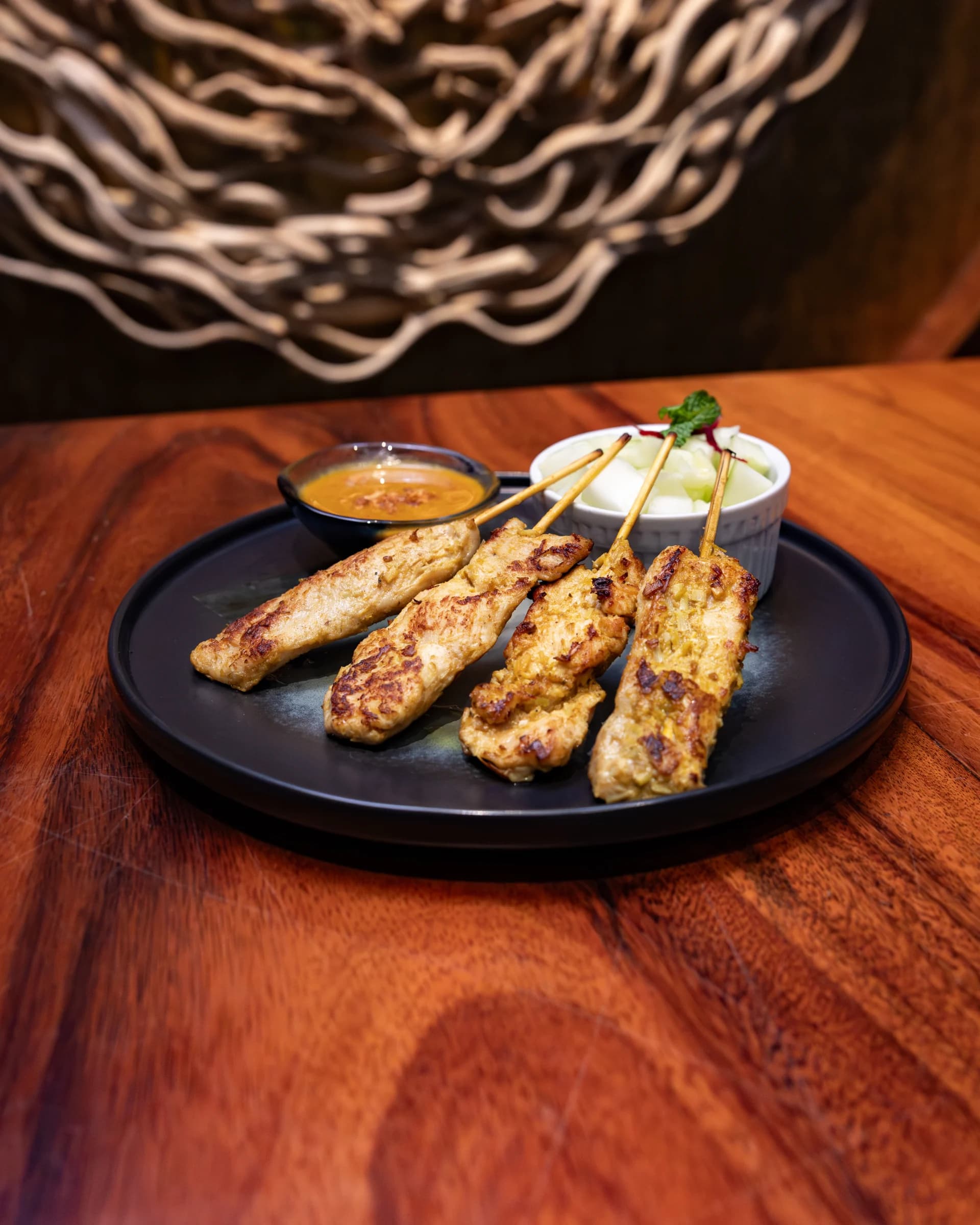Satay Kai chicken skewers with peanut sauce and cucumber relish